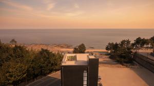 a view of the ocean from a building at Goseong Belossi Ayajin Kids Poolvilla in Goseong