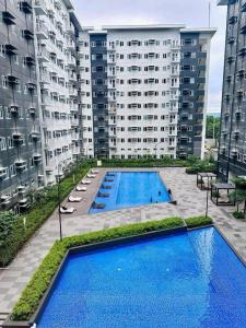 an aerial view of an apartment complex with two pools at Aventura Presidential Suite at SMDC Charm Residences in Manila