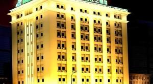 a tall white building is lit up at night at Jinjiang Inn Tianjin Station Jinwan Square in Tianjin