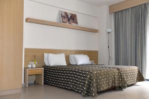 Postel nebo postele na pokoji v ubytování Kyridis Hotel