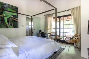 a bedroom with a bed and a table and chairs at Africa Lodge in Somerset West