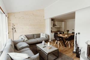 a living room with a couch and a table at Harzchalet Brockenbahn 2A in Elend