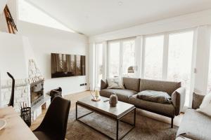 a living room with a couch and a table at Harzchalet Brockenbahn 2A in Elend