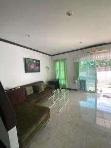 ein Wohnzimmer mit Couch und großem Fenster in der Unterkunft Baan Rungrojn HuaHin in Hua Hin