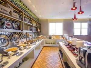 a large room with a kitchen with dishes on the counters at Borrman Hotel Nanning Railway Station in Nanning
