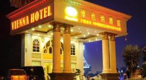 a sign in front of a building at night at Vienna Hotel Chengdu Exhibition Center in Chengdu +47 photos