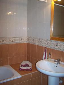 a bathroom with a sink and a bath tub and a sink at Casa la Cuadreta in Calvera +29 photos