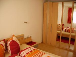 1 dormitorio con cama y espejo grande en Appartement Lea, en Umhausen
