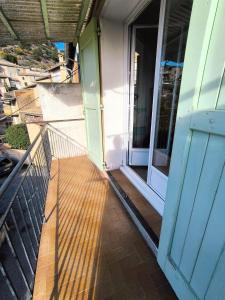 an open door to a balcony with a porch at La Maison de la Baume in Volonne