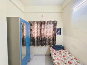 a small room with a bed and curtains at Shree Sairam Pg For Gents in Pune