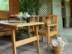 a wooden table with two chairs and wine glasses at Center Apartments Bludenz in Bludenz