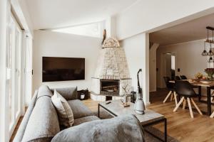 a living room with a couch and a fireplace at Harzchalet Brockenbahn 2B in Elend