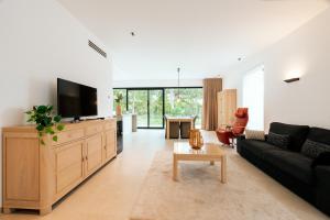 a living room with a couch and a flat screen tv at Bocca in Hasselt