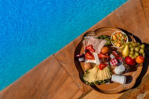 a plate of food on a table next to a pool at Talizeti Home - Adults Only in Sarti +142 photos
