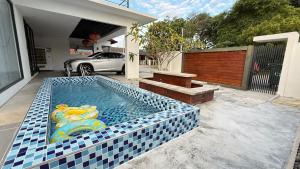 a swimming pool in the backyard of a house at Leisure29 Suites in Kuantan