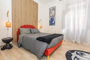 um quarto com uma cama vermelha e uma cadeira vermelha em Msuite em Giarre