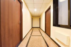 an empty corridor in an office building with a hallway at FabHotel The Grand Manmuralidhar - Hawa mahal 3 km, Chandpol metro station in Jaipur