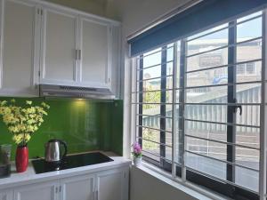 a kitchen with a sink and a large window at Phương Đông 502DT in Hanoi