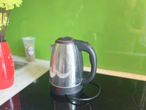 a black and silverffeepot sitting on a table at Phương Đông 502DT in Hanoi