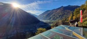 een uitzicht op een vallei vanuit een huis, waar de zon op schijnt bij Großstahlhof Mountain & Panorama View in San Giovanni in Val Aurina