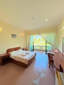 a bedroom with a bed and a large window at Met Blue Ocean Resort in Mersing