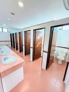 a bathroom with a row of sinks and toilets at Met Blue Ocean Resort in Mersing +24 photos