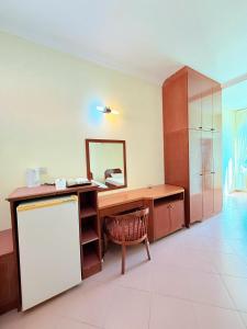 a kitchen with a desk and a mirror and a chair at Met Blue Ocean Resort in Mersing