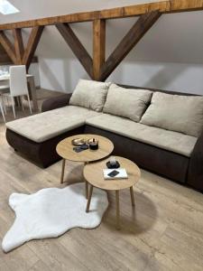 a living room with a couch and two tables at La Casa 2 in Sombor