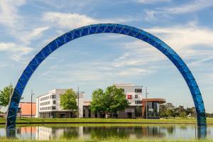 a blue arch over a body of water at ibis budget Saint Quentin Yvelines - Vélodrome in Montigny-le-Bretonneux
