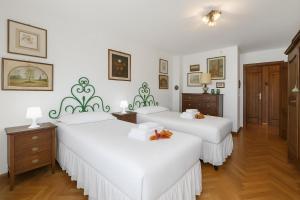 En eller flere senge i et værelse på Appartamento Aricami - Happy Rentals