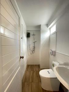 a bathroom with a toilet and a sink at Chermonné House เฌอมอญ 