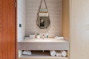 a bathroom with a sink and a mirror at Atour S Hotel SHanghai Baoshan Gucun Park in Shanghai +19 photos