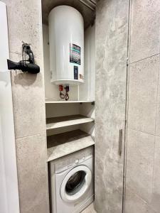 a washer and dryer in a small room at Designer luxury Appartment in Kharkiv