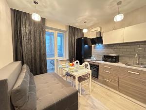 a kitchen and living room with a couch and a table at Designer luxury Appartment in Kharkiv