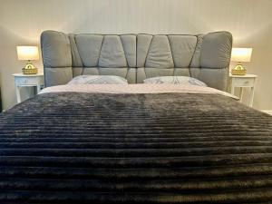 a bedroom with a large bed with two tables at Designer luxury Appartment in Kharkiv