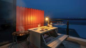 a small table on the balcony of a room at Goseong Badasga per Osyeonbyu Pension in Goseong