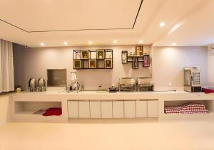 a kitchen with a sink and a counter top at City Comfort Inn Nanning Guangxi University Xiuling Road Metro Station in Nanning