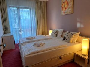Ένα ή περισσότερα κρεβάτια σε δωμάτιο στο Apartmány hotela CROCUS Štrbské Pleso