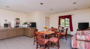Baymont by Wyndham Acworth في أكوورث: مطبخ وغرفة طعام مع طاولة وكراسي