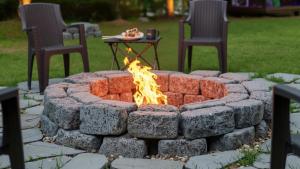 a fire pit with two chairs and a table at Gapyeong Daengdaengi Dog Pension Silver in Gapyeong