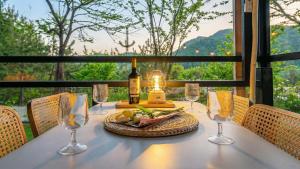 a table with a bottle of wine and wine glasses at Gapyeong Daengdaengi Dog Pension Silver in Gapyeong +1 photo