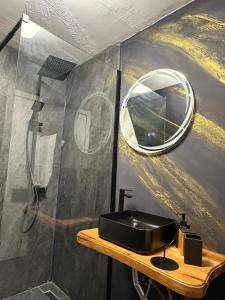 a bathroom with a sink and a mirror at Wild Hill Apuseni in Gârda de Sus +37 photos