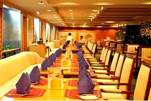 a long table in a restaurant with chairs and desks at Dolton Hotel Changsha in Changsha