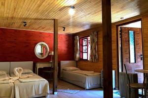 a room with two beds and a mirror at Vērbeļnieki in Pērkone