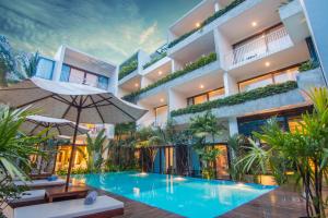 a hotel with a swimming pool in front of a building at Apsara Residence Hotel in Siem Reap