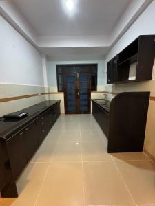 a large kitchen with black cabinets and a door at Hotel Lake Vista Stays in Udaipur