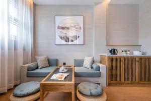 a living room with a couch and a table at Atour S Hotel SHanghai Baoshan Gucun Park in Shanghai
