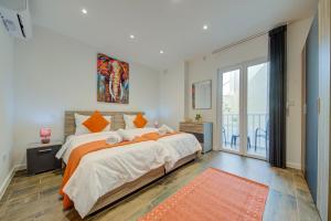 a bedroom with a large bed and a balcony at Ridge View Rooms - in a Shared Apartment - Sea Views in Mellieħa