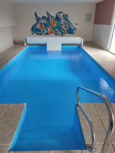 una piscina con agua azul en un edificio en Gîte avec piscine d'intérieure, 