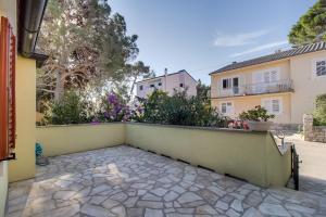 a balcony of a house with a wall at Adriana Apartment in Mali Lošinj